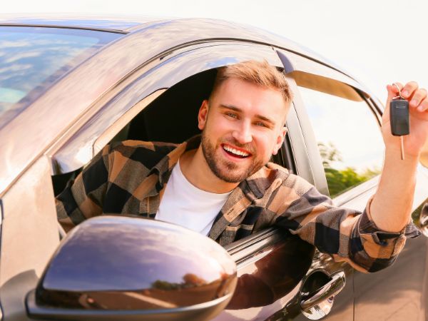 Man showing car keys in a rental car